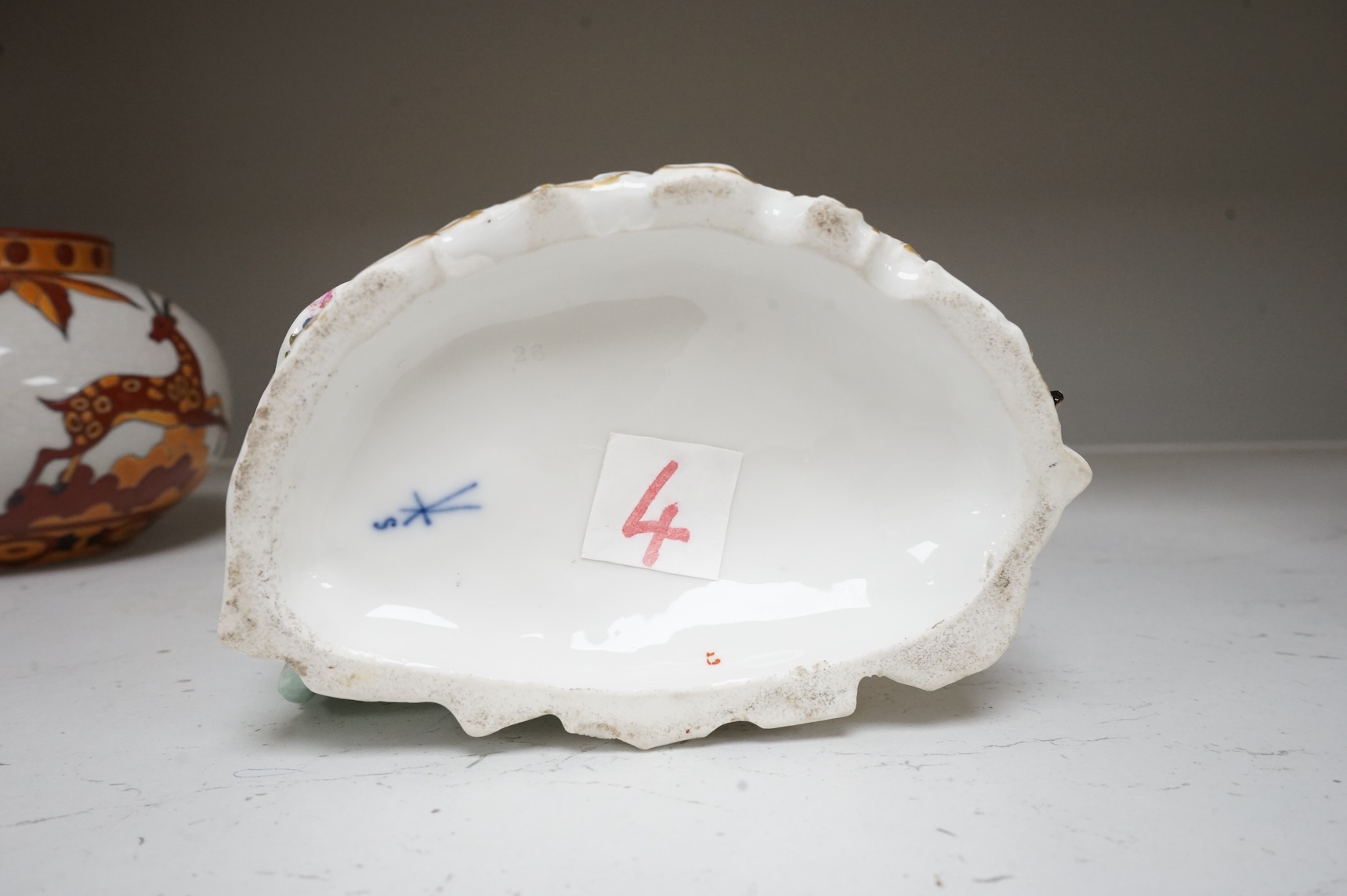 A German porcelain group of a seated courting couple, 16.5cm high